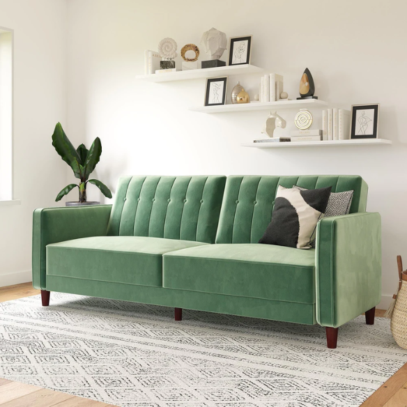 Muted green velvet convertible sofa featuring vertical tufting, square arms, split-back reclining design, and wood tapered legs with twin-size sleeper functionality.