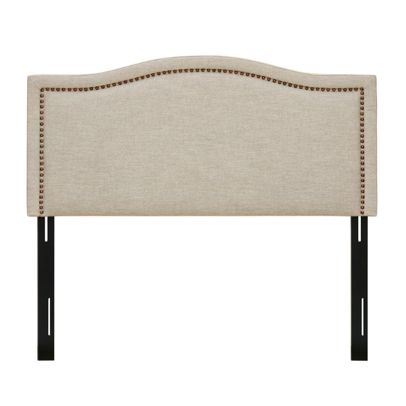 Natural beige upholstered king headboard with curved silhouette, silver nailhead trim, and adjustable metal legs for bed frame mounting