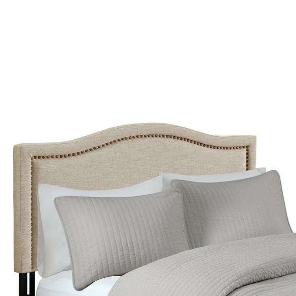 Natural beige upholstered king headboard with curved silhouette, silver nailhead trim, and adjustable metal legs for bed frame mounting