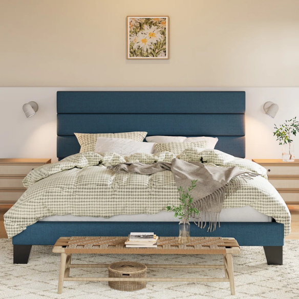 Navy blue king-size upholstered platform bed with rectangular headboard, padded linen-blend fabric, and slat support system