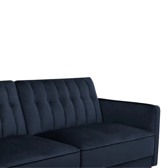 Navy blue velvet convertible sofa with vertical tufting, square arms, and brown tapered legs, designed with a split-back reclining feature and twin bed conversion.