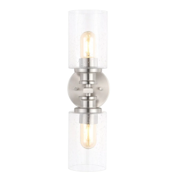Brushed nickel wall sconce with two clear seeded glass cylinder shades and Edison-style LED bulbs, perfect for bathrooms or hallway accent lighting