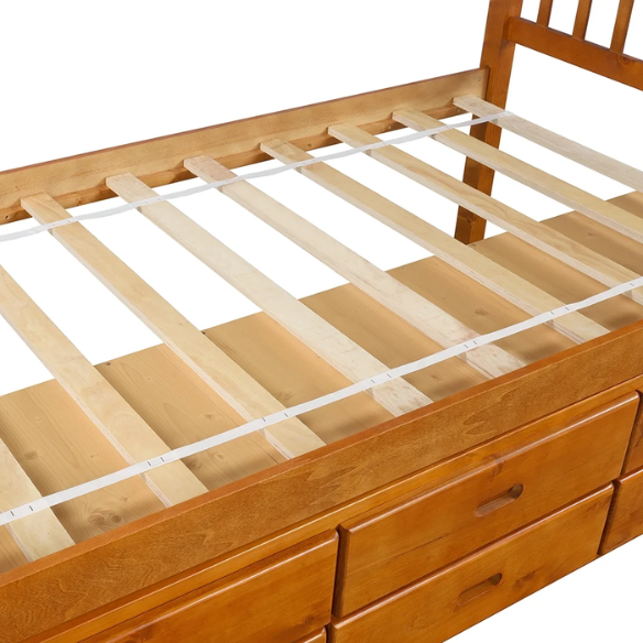 Oak twin bed frame made of solid pine wood with underbed storage drawers, eco-friendly finish, and slatted base, ideal for children or teens in a rustic or modern bedroom.