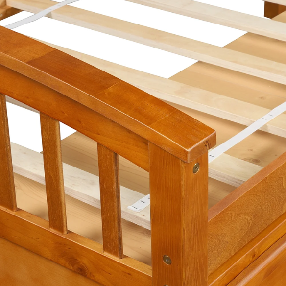 Oak twin bed frame made of solid pine wood with underbed storage drawers, eco-friendly finish, and slatted base, ideal for children or teens in a rustic or modern bedroom.