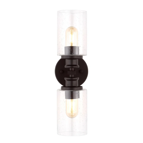 Oil-rubbed bronze wall sconce with dual clear seeded glass cylinder shades and Edison-style LED bulbs, perfect for rustic, farmhouse, or traditional interiors