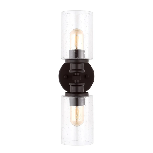 Oil-rubbed bronze wall sconce with dual clear seeded glass cylinder shades and Edison-style LED bulbs, perfect for rustic, farmhouse, or traditional interiors