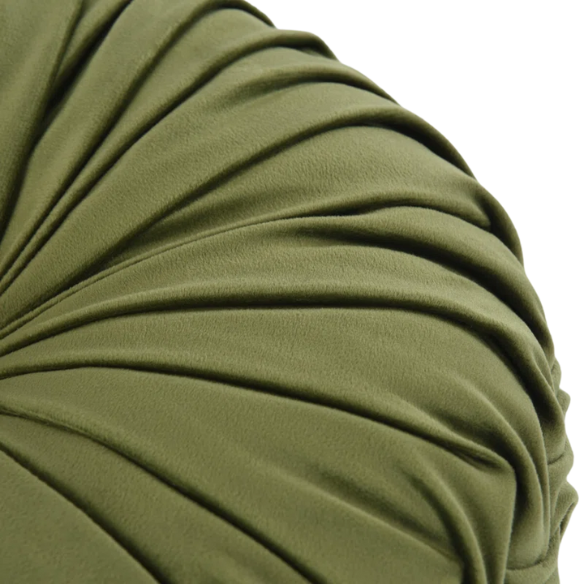 Olive green velvet round throw pillows with hand-pleated detailing and button center, styled on a beige sofa for a warm, inviting look.