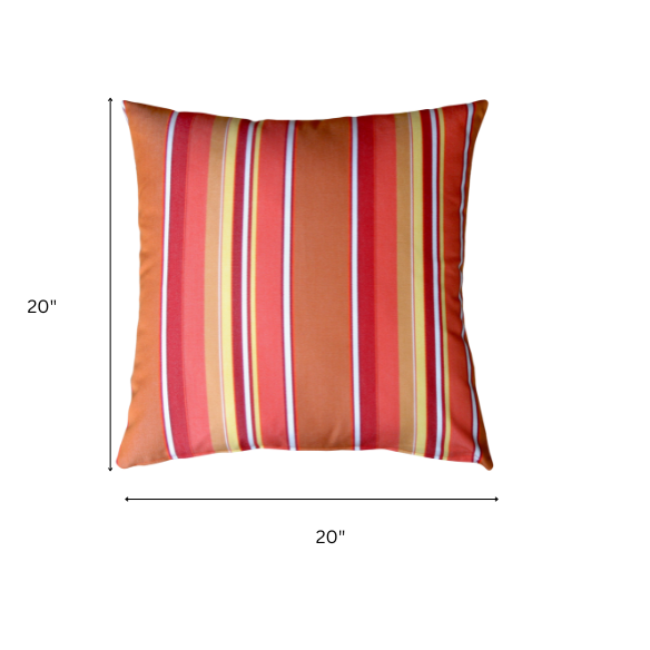 Striped accent pillow in vibrant orange, red, yellow, and white – reversible, weather-resistant, and overstuffed with polyester fill for indoor or outdoor use.
