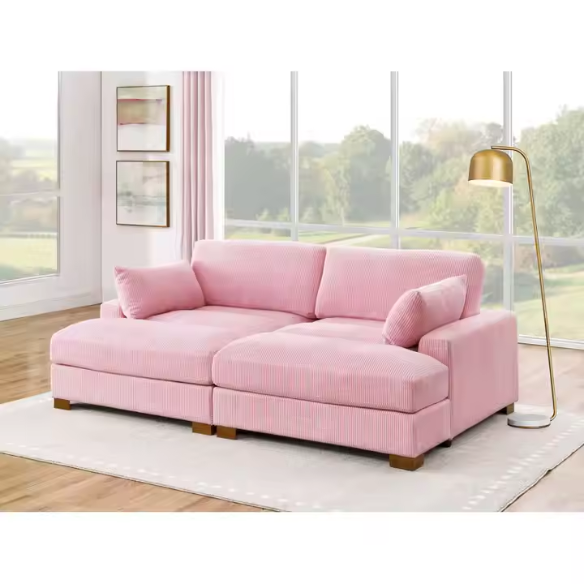 Pink corduroy convertible sleeper sofa with adjustable headrest, twin bed functionality, and mid-century wood legs