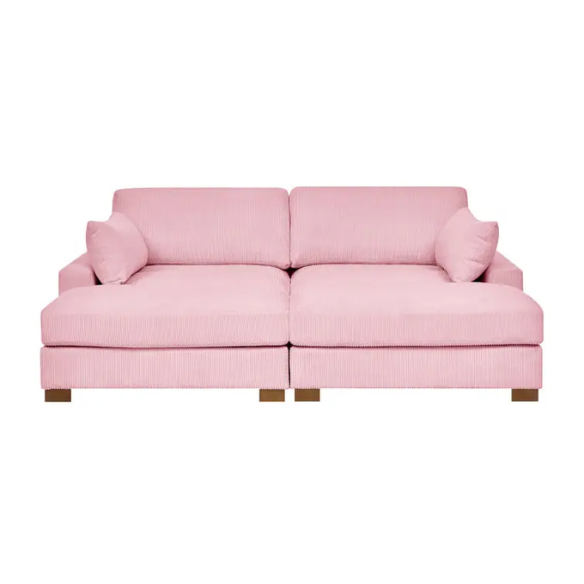 Pink corduroy convertible sleeper sofa with adjustable headrest, twin bed functionality, and mid-century wood legs
