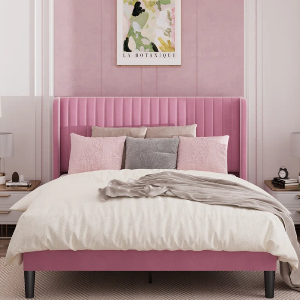 Pink full-size velvet upholstered platform bed with tufted wingback headboard and wood slats