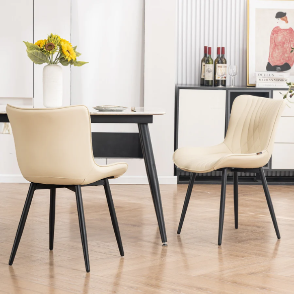 Set of 2 beige faux leather dining chairs with modern fishtail backrest and black metal legs, designed for contemporary dining spaces.