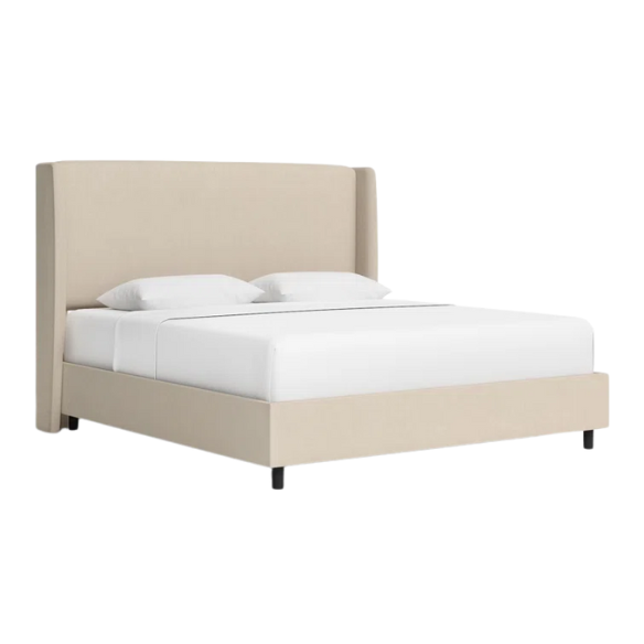 Beige king-size upholstered bed in linen fabric with wingback headboard and low-profile black metal legs.