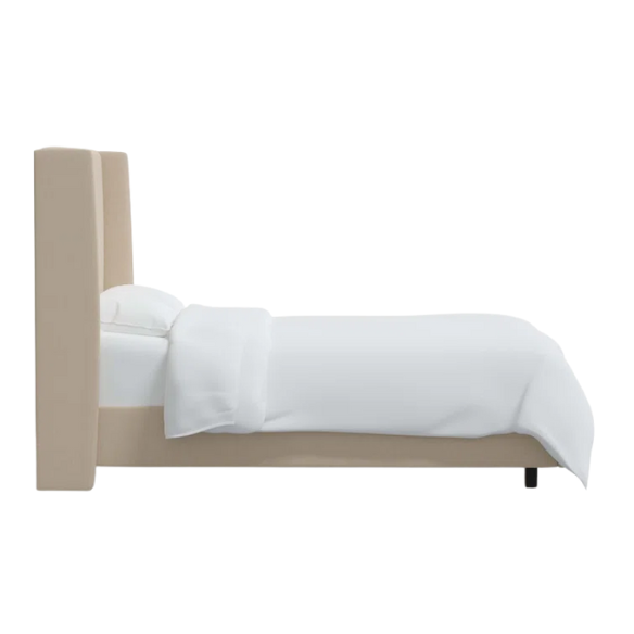 Beige king-size upholstered bed in linen fabric with wingback headboard and low-profile black metal legs.