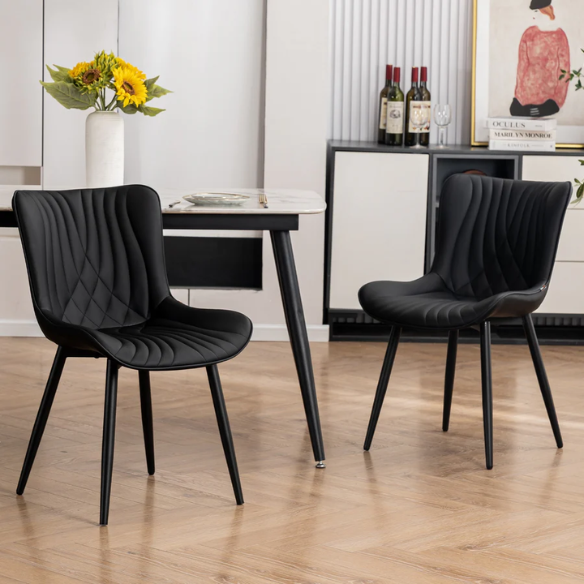 Set of 2 black faux leather dining chairs with fishtail backrest design and black metal legs, ideal for modern and contemporary dining spaces.