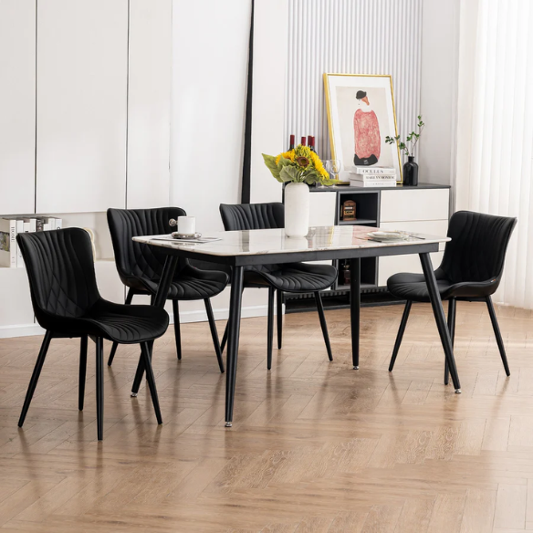 Set of 2 black faux leather dining chairs with fishtail backrest design and black metal legs, ideal for modern and contemporary dining spaces.