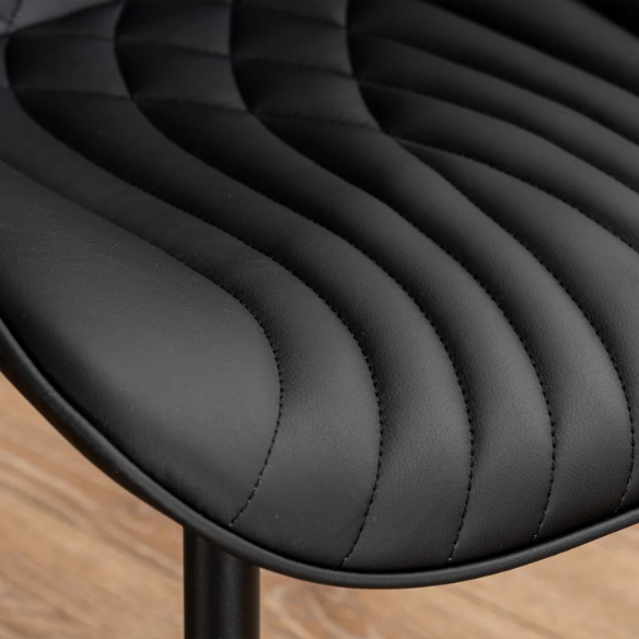 Set of 2 black faux leather dining chairs with fishtail backrest design and black metal legs, ideal for modern and contemporary dining spaces.
