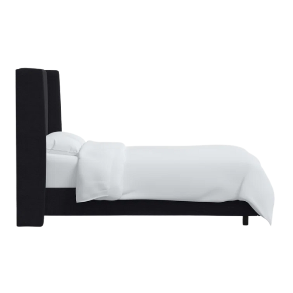 Black king-size upholstered bed in linen fabric with wingback headboard and low-profile black metal legs.