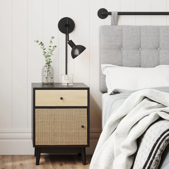 Black plug-in wall sconce with adjustable metal arm and bell-shaped shade, featuring inline on/off switch and matching black cord cover, ideal for task lighting or bedside use.