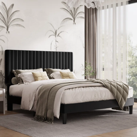Black velvet upholstered queen bed with tufted wingback headboard and low-profile frame.