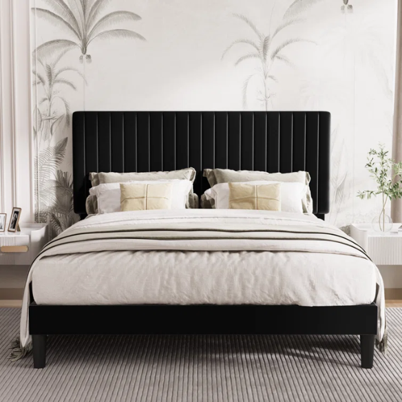 Black velvet upholstered queen bed with tufted wingback headboard and low-profile frame.