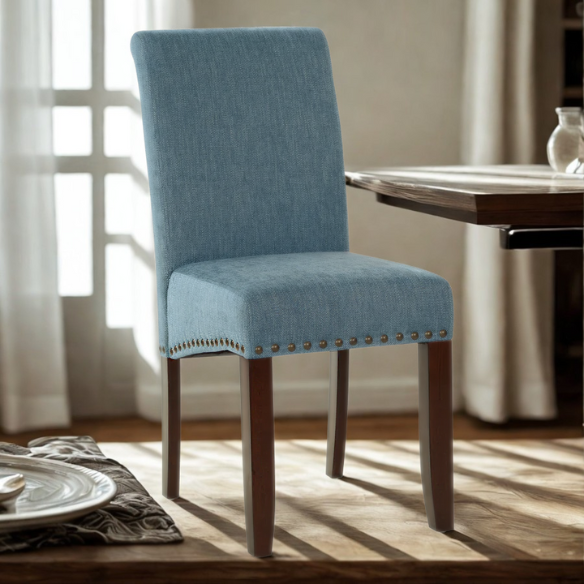 Blue denim upholstered Parsons chair with scrolled back, antique bronze nailhead trim, and solid wood legs