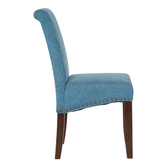 Blue denim upholstered Parsons chair with scrolled back, antique bronze nailhead trim, and solid wood legs