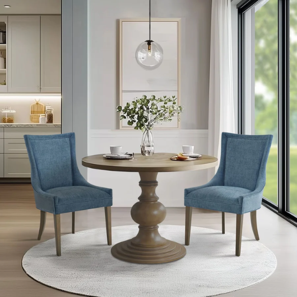 Set of 2 upholstered armless dining chairs in rich blue chenille with solid wood legs, high backs, and piped detailing.