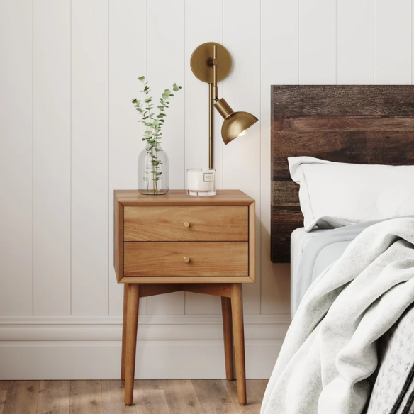 Brass plug-in wall sconce with adjustable swing arm and bell shade, featuring a built-in switch and cord cover for modern bedroom or reading nook lighting