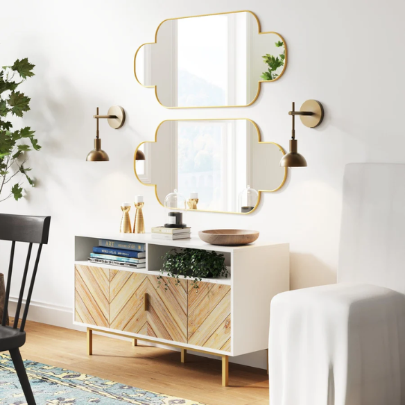 Brass plug-in wall sconce with adjustable swing arm and bell shade, featuring a built-in switch and cord cover for modern bedroom or reading nook lighting