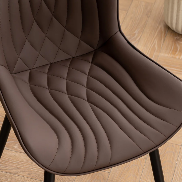 Set of 2 brown faux leather dining chairs with fishtail tufted backs and black metal legs, ideal for modern or rustic dining spaces.