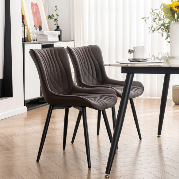 Set of 2 brown faux leather dining chairs with fishtail tufted backs and black metal legs, ideal for modern or rustic dining spaces.