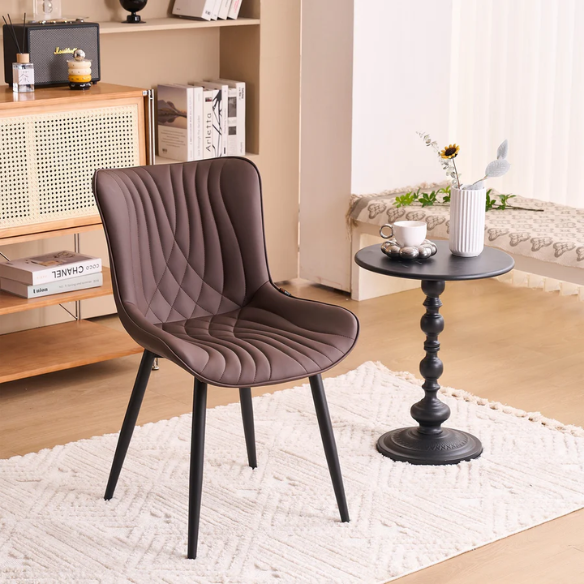 Set of 2 brown faux leather dining chairs with fishtail tufted backs and black metal legs, ideal for modern or rustic dining spaces.