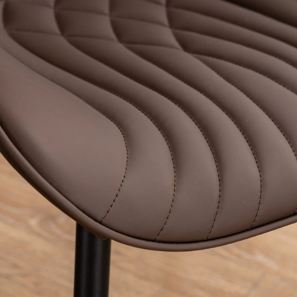 Set of 2 brown faux leather dining chairs with fishtail tufted backs and black metal legs, ideal for modern or rustic dining spaces.