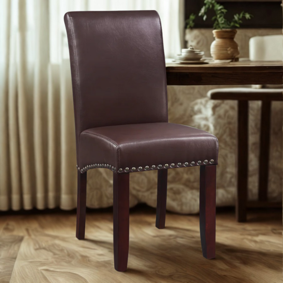Brown faux leather Parsons chair with scrolled back, antique bronze nailhead trim, and solid wood legs