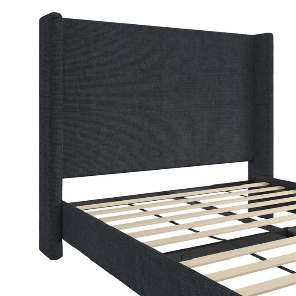 Dark blue canvas queen-size platform bed with tall wingback headboard and black tapered legs.