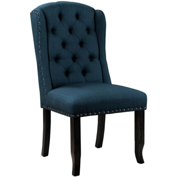Set of two dark blue upholstered farmhouse dining chairs with tufted backs, brass nailhead trim, and antique black wood legs.