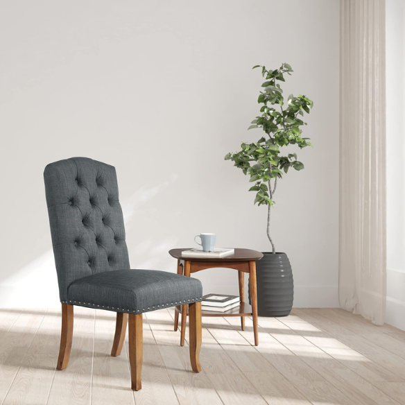 Set of 2 dark grey button-tufted farmhouse dining chairs with rustic wood legs, nailhead trim, and upholstered linen-like fabric.