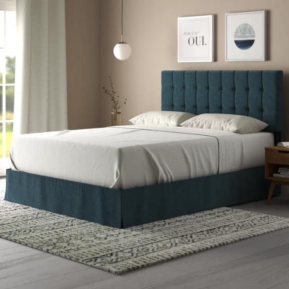 Denim blue upholstered queen bed with tufted wingback headboard and nailhead trim on wood and metal frame.