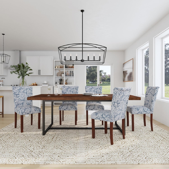 Set of two Parsons dining chairs with denim blue and white floral upholstery, high back design, scalloped seat front, and wood legs