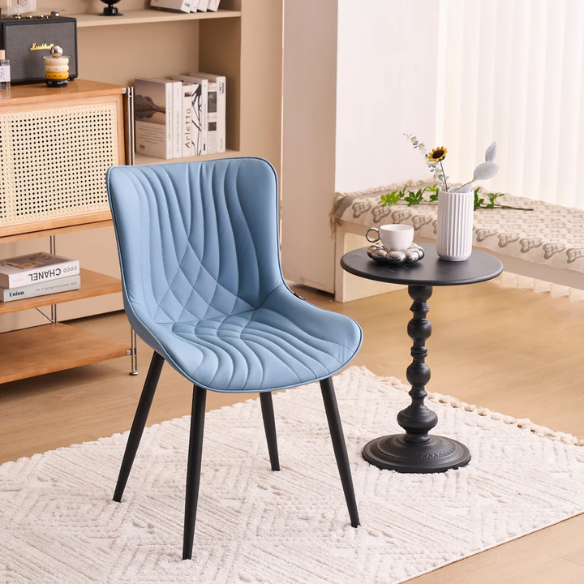 Set of 2 dusty blue faux leather dining chairs with fishtail tufted back and black metal legs, perfect for modern dining rooms or kitchen spaces.