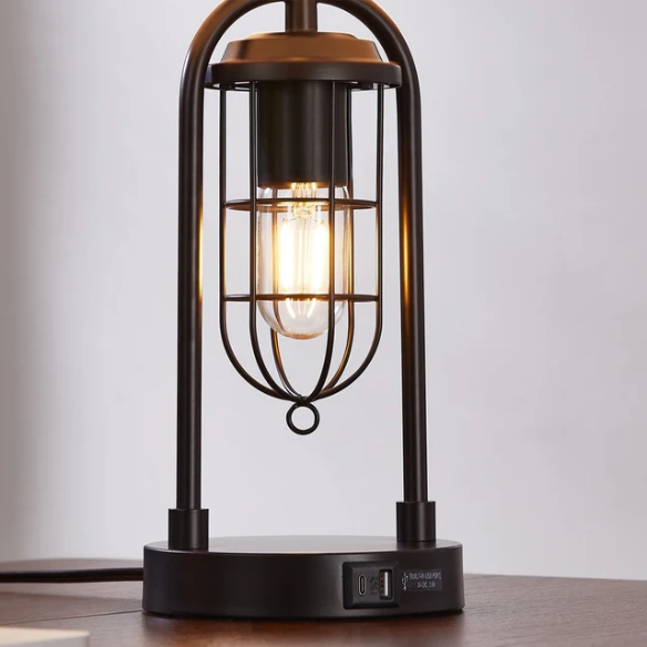 Set of two 21.5-inch espresso table lamps with arch-shaped metal bases, beige fabric drum shades, built-in USB-A and USB-C charging ports, and lantern-style night lights — ideal for modern, industrial, or transitional interiors.