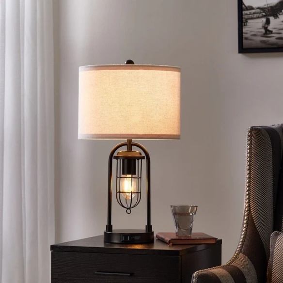 Set of two 21.5-inch espresso table lamps with arch-shaped metal bases, beige fabric drum shades, built-in USB-A and USB-C charging ports, and lantern-style night lights — ideal for modern, industrial, or transitional interiors.