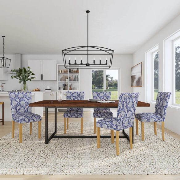 Set of two blue and cream floral Parsons dining chairs with high back, scalloped seat front, and wood legs in a traditional design