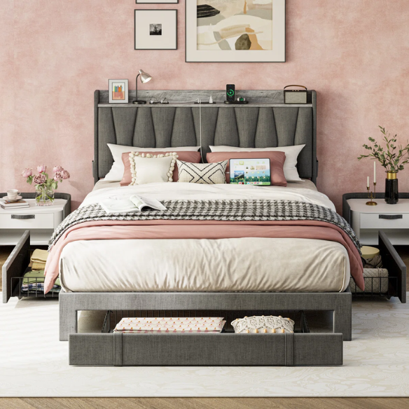 Full size dark grey upholstered platform bed with padded linen headboard, built-in storage shelf and charging station, and three underbed rolling drawers for extra storage.