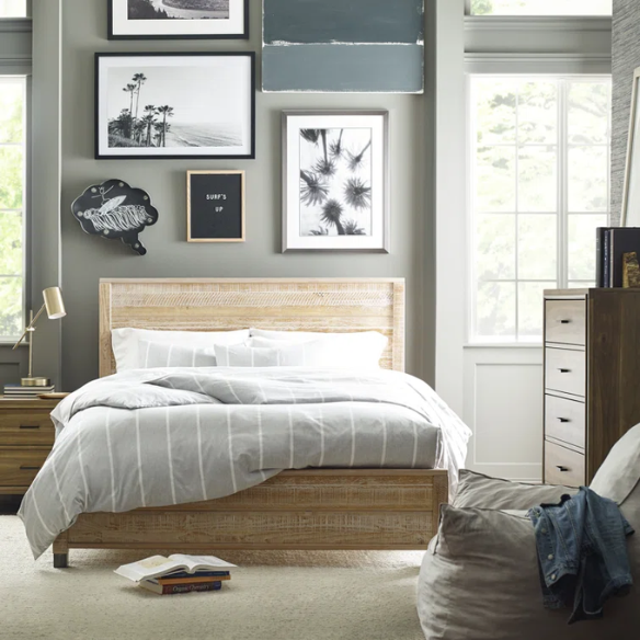 Full-size farmhouse bed in light tan finish, made from solid pine wood with a distressed texture, rectangular headboard and footboard, and slatted platform design.