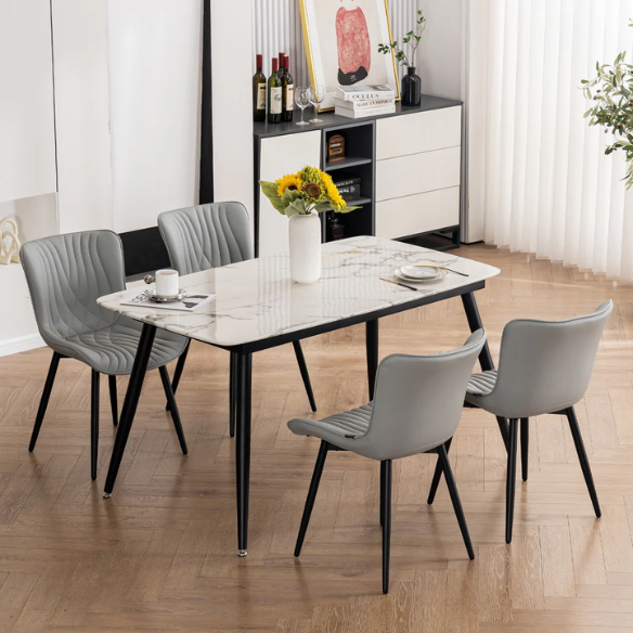 Set of 2 grey faux leather dining chairs with fishtail tufted backs and black metal legs, ideal for modern and minimalist dining room interiors.