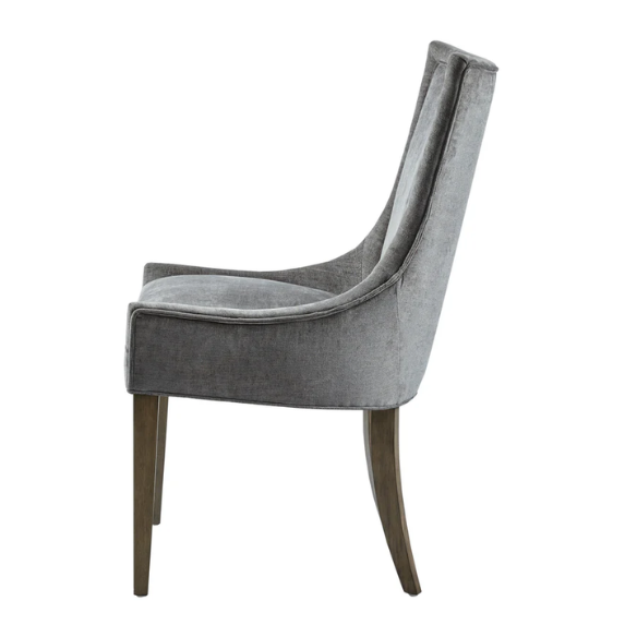 Set of 2 upholstered armless dining chairs in soft grey chenille with high backs, piped detailing, and solid wood legs.
