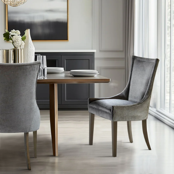 Set of 2 upholstered armless dining chairs in soft grey chenille with high backs, piped detailing, and solid wood legs.