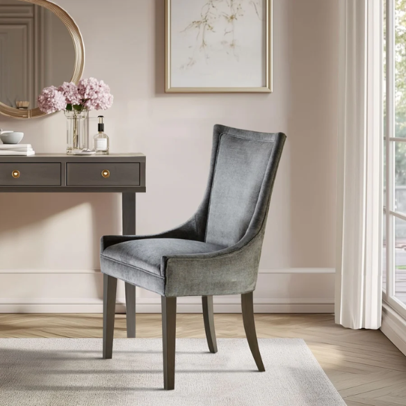 Set of 2 upholstered armless dining chairs in soft grey chenille with high backs, piped detailing, and solid wood legs.